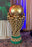 Close-up of a giant gold balloon soccer trophy sculpture with green balloon base at a FIFA World Cup event setup.
