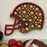 Decorative helmet with gold balls, red balloons, and a football on a white background
