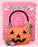 A balloon pumpkin bucket photo op featuring an oversized jack-o-lantern made of orange balloons with black face details, decorated with balloon candies and a black twisted handle. The backdrop is a wall of pink balloons with a white “Trick or Treat” banner, making this a playful and eye-catching Halloween balloon display for parties, schools, and festive events.