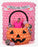 A large balloon pumpkin bucket photo op decorated with orange balloons, black jack-o-lantern face, and oversized balloon candies, set against a pink balloon wall with a “Trick or Treat” banner. Perfect Halloween balloon decor idea for parties, school events, and festive photo backdrops.