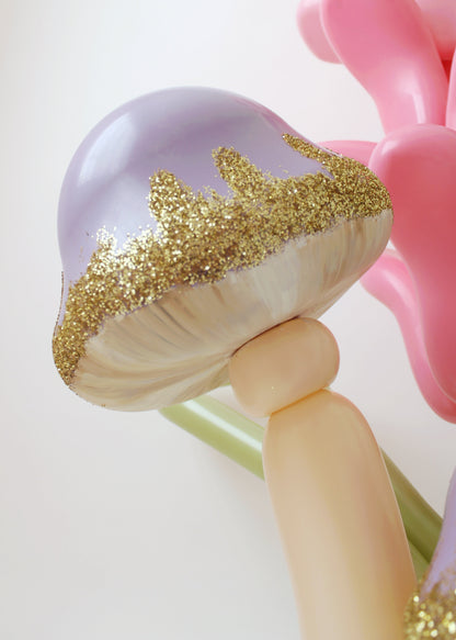 Detailed view of a purple balloon mushroom with gold glitter edges, part of Lilly Jimenez’s decor.