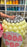 Close-up of a K-pop Demon Hunters inspired balloon soda pop prop featuring pastel yellow balloons forming the can, a silver balloon tab on top, and a “My Little Soda Pop” label, shown in a studio with organized balloon supplies in the background.