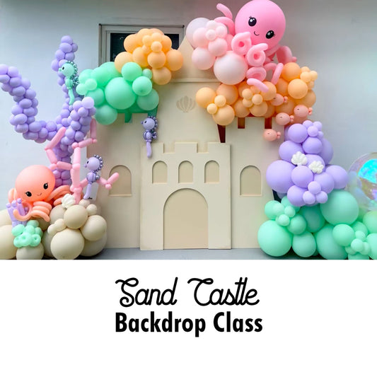 Sand Castle Backdrop Class DIY project featuring a large foam board castle surrounded by pastel balloon decor including octopuses, coral, and underwater plants. Ideal for under-the-sea parties, princess themes, or summer celebrations. Learn to create this backdrop with templates, cut lists, and a video tutorial from The Creative Heart Studio.