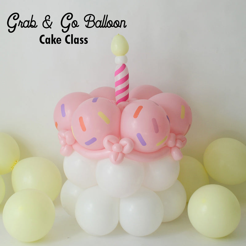 A cute balloon cake featuring pastel pink balloon “frosting” with colorful sprinkle cutouts, white balloon base, and a whimsical striped candle on top. Perfect for party deliveries, grab & go setups, or birthday-themed balloon decor. Learn how to make this easy and festive design in the Grab & Go Balloon Cake Tutorial—includes downloadable SVG sprinkle file for Cricut or Silhouette users.