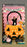 A Halloween balloon pumpkin bucket photo op featuring an oversized orange jack-o-lantern made of balloons, filled with balloon candy decorations and set against a pink balloon wall with a “Trick or Treat” banner. A person poses inside the bucket, showcasing this festive Halloween balloon decor idea for parties, schools, and event backdrops.