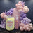 K-pop Demon Hunters inspired balloon setup featuring a pastel soda pop can made of balloons with a “My Little Soda Pop” label, a pink bottle prop with the name “MIA,” and clusters of pink, purple, and cream balloons accented with metallic lavender stars, perfect for K-pop Demon Hunters themed parties and pop culture celebrations.
