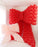 Red and pink balloon bow decorations on a white wall