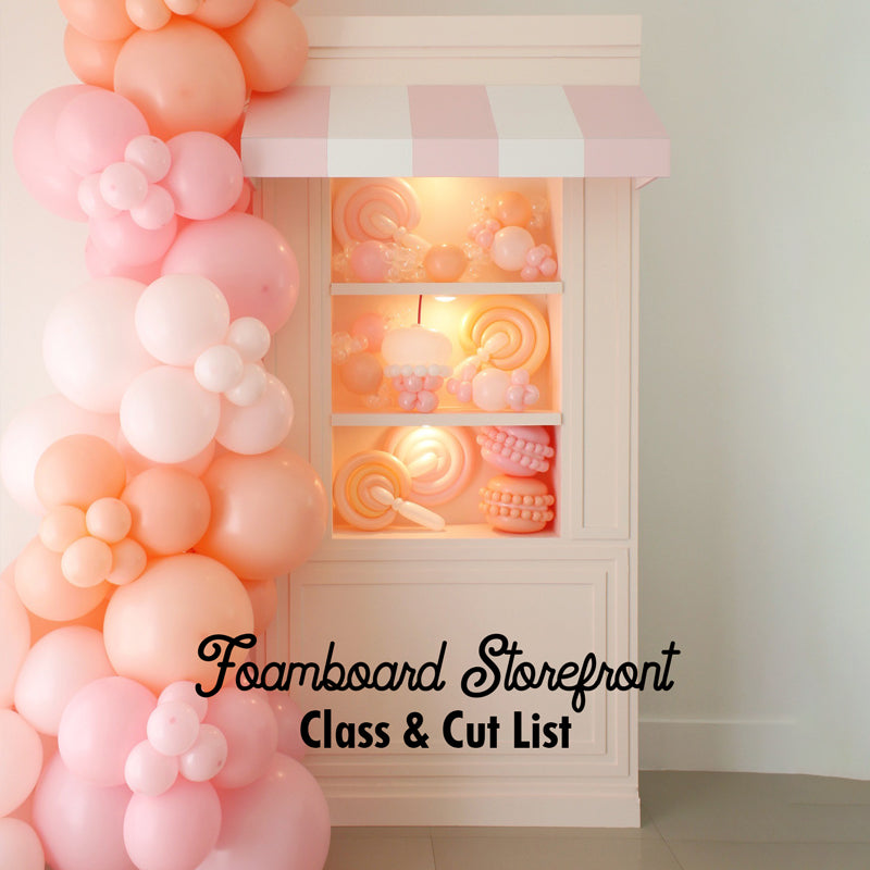 Foamboard Storefront DIY display featuring pastel pink and peach balloon garland with candy-inspired balloon props inside. Includes striped awning and built-in shelves. Perfect for parties, photo booths, and events. Part of the Foamboard Storefront Class with full video tutorial and cut list from The Creative Heart Studio.