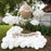 Gender Reveal Hot Air Balloon display featuring a beige and white jumbo balloon with paper bows, a basket filled with flowers, and a banner reading “Our Next Great Adventure,” surrounded by white balloon clouds, perfect for baby showers, gender reveal parties, and adventure-themed celebrations.