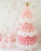Pink balloon Christmas tree with a slightly pointed top made from layered pink and white balloons and finished with a gold star. White balloon snowflakes cover the wall behind it, and soft pastel pink balloons sit at the base. This whimsical holiday backdrop is the same design you can learn step by step inside the Whimsical Balloon Christmas Tree Class, ideal for Christmas installs and photo setups.