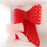 Two linking balloon bows, one oversized in red and a smaller bow in blush pink, displayed side by side to show class size variations. Perfect visual for the two bow sizes taught in the Linking Balloon Bows Class.