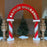Red and white Santa’s Workshop balloon arch with candy cane style columns and festive Christmas decor, perfect for holiday parties, Santa meet and greets, photo backdrops, and winter event balloon installations.