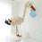 Neutral stork balloon sculpture holding a blue balloon bundle, designed as a welcome baby display for newborn arrivals, baby showers, nursery decor, and professional balloon installations.