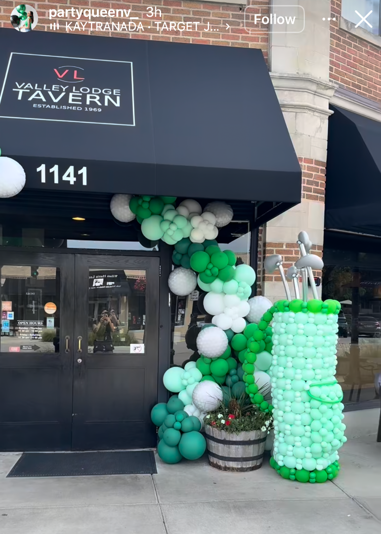Student made balloon decor featuring a green and white balloon arch and balloon structure installed outside a restaurant storefront. Created by Creative Heart Studio student @partyqueenv_, this real world balloon installation showcases professional event decor skills taught inside balloon classes for storefront openings, brand activations, and holiday events.