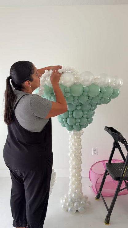 Lilly Jimenez attaching the white balloon salt rim to an oversized Margarita Glass Balloon Sculpture