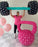 Lilly Jimenez lifting oversized balloon barbell above her head with large pink balloon kettlebell in front, fitness themed balloon decor for gym events, workout parties, and health brand activations.