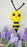 Classic balloon bee sculpture with yellow body, black stripes and white wings floating above purple balloon flowers. Spring garden theme balloon decor designed for birthday parties, baby showers and professional event installations.