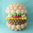 Balloon burger centerpiece with layered bun, lettuce, tomato, cheese, and patty on blue background