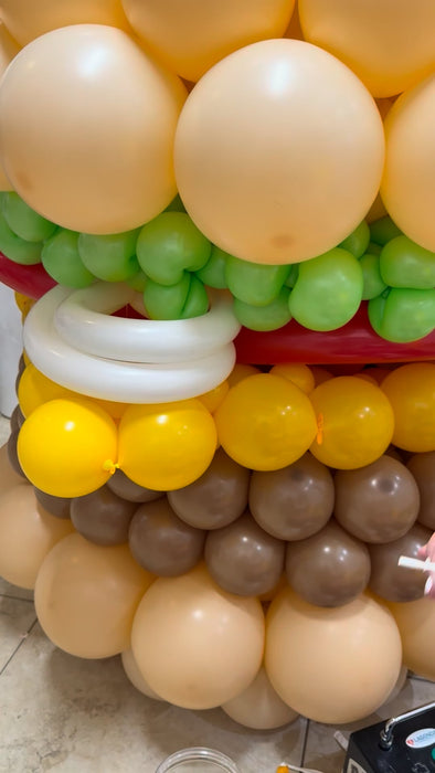 Close up of balloon burger layers showing bun, lettuce, tomato, cheese, and patty details