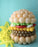 Balloon burger sculpture with yellow balloon fries on blue background