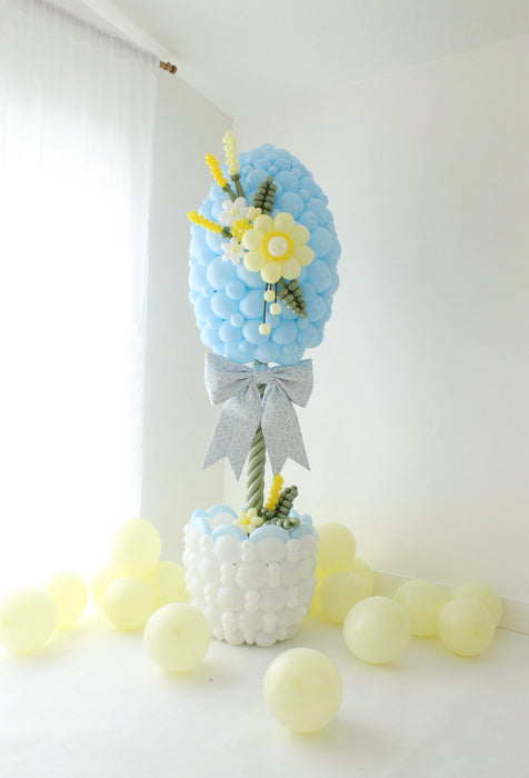 close up of Easter egg balloon column with balloon flower detail and layered design for spring balloon decor