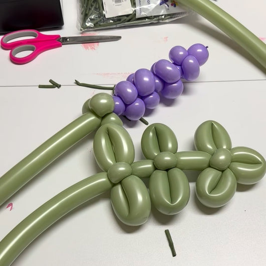 Learn to make balloon lavender and rosemary sprigs using twisting balloons, pinch twists, loops, and custom stems for floral and themed balloon decor.