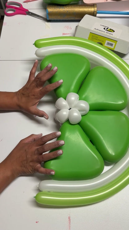 Close-up of a handmade balloon lime wedge created with green and white balloons