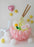 Balloon ramen bowl centerpiece with pink balloon base, spiral noodles, egg, fish cake, chopsticks, and star balloons on white background