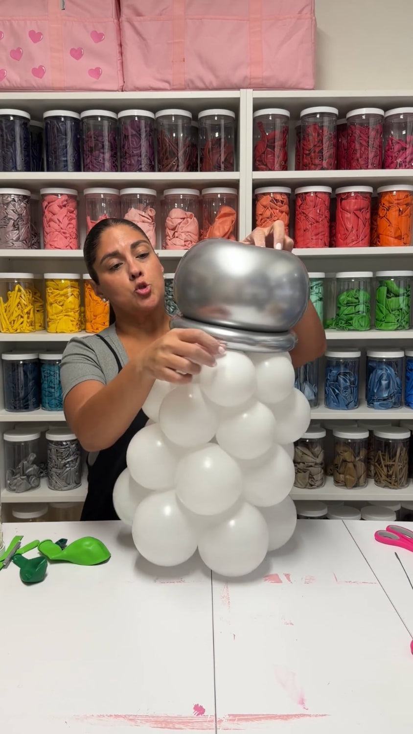 Lilly Jimenez creating a white and silver balloon salt shaker for the Margarita Glass Balloon Sculpture