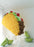 Large balloon taco sculpture with layered fillings and lime slice props on floor