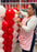Lilly assembling red and white striped balloons for the giant balloon popcorn bucket in the Cinema Party Decor Class, teaching movie night balloon decorations, Hollywood themed party props, and DIY cinema event decor.