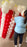 Lilly assembling the giant balloon popcorn bucket with red and white striped balloons, white popcorn balloon clusters, and yellow butter accents for the Cinema Party Decor Class, movie night decorations, and Hollywood themed party displays.