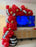 Red movie night balloon garland with film strip details, gold star balloons, and oversized film reel props for cinema party decor, Hollywood themed birthdays, award show events, theater parties, and family watch party displays.