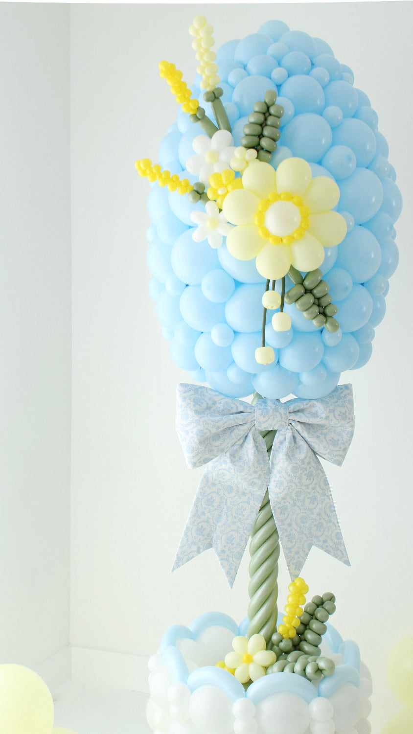 Easter balloon column topiary with oversized bow detail and basket base for sellable spring balloon design