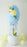 side view of Easter egg balloon column topiary with basket base, balloon flowers, and bow for spring event decor