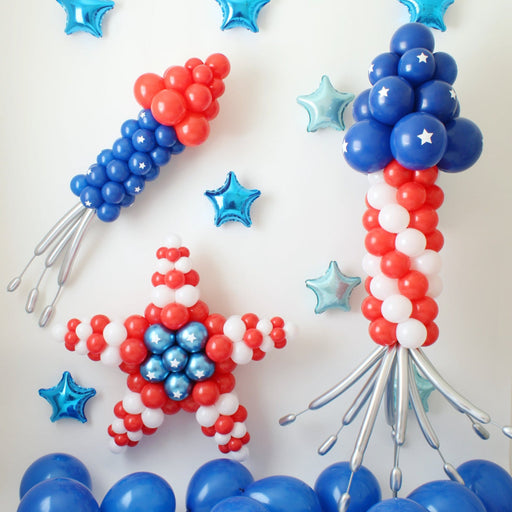 Patriotic Balloon Decorations Fireworks image showing red, white, and blue balloon rockets, a balloon star, and metallic star balloons for Fourth of July party decor