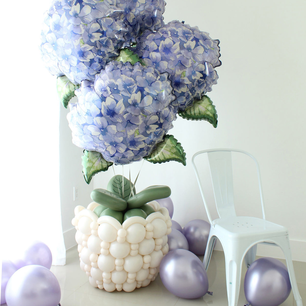 Linking balloon flower pot with oversized hydrangea foil balloons and green balloon leaves for floral balloon decor.