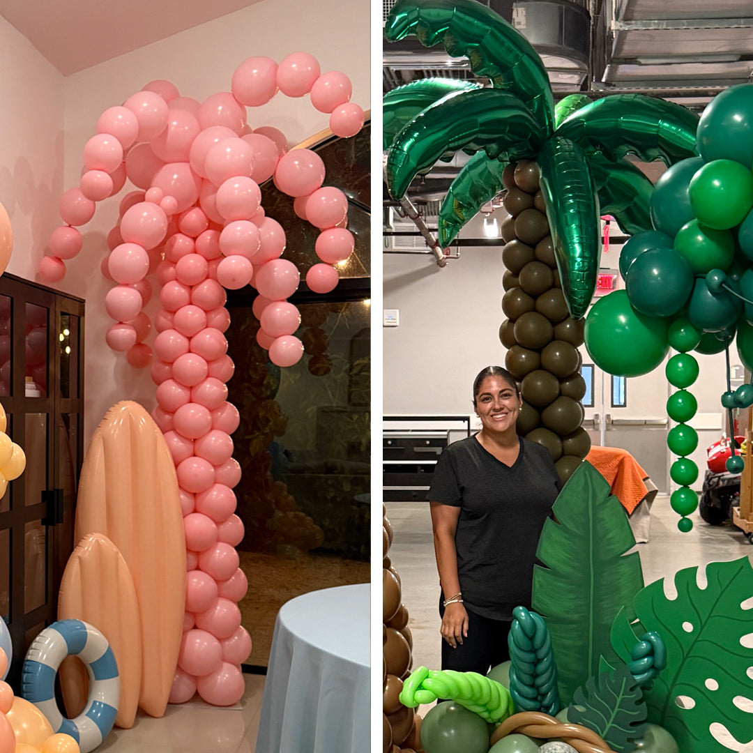 Finished pink and green balloon palm tree designs with surfboards, tropical leaves, and jungle props for luau, beach party, and summer event decor.