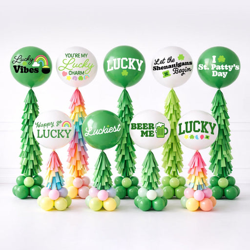 St. Patrick’s Day SVGs for jumbo balloons designed for Cricut cutting machines, featuring Lucky, Beer Me, shamrock, and festive holiday phrases sized for 36 inch balloons. Perfect for balloon artists creating St. Patrick’s Day balloon stands with layered tassels and green base clusters in a clean studio display.