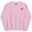 A light pink sweatshirt featuring a minimalist design of three heart-shaped balloons in shades of pink and red, tied together with a small bow, located on the upper left chest area.