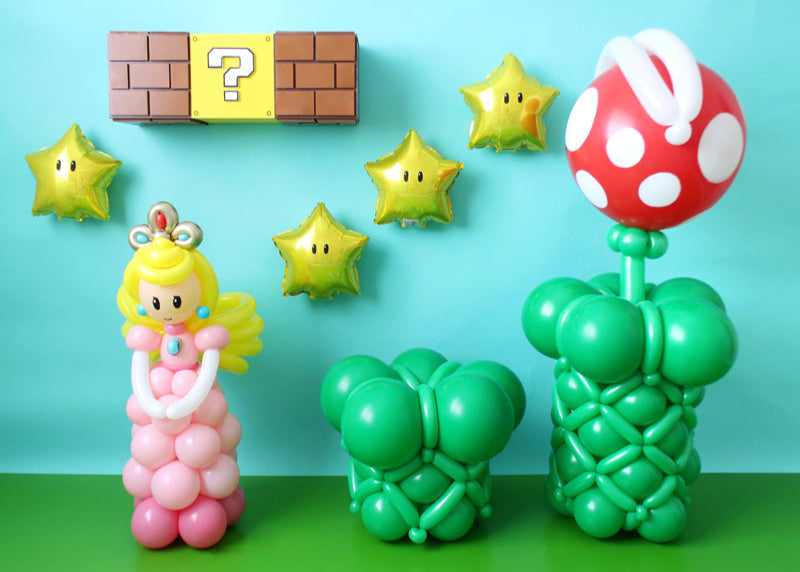 Super Mario Party Decoration Ideas. Star Foil Balloons with eyes. Piranha Plant and princess peach. Luck Box and Bricks decoration made out of foamboard.