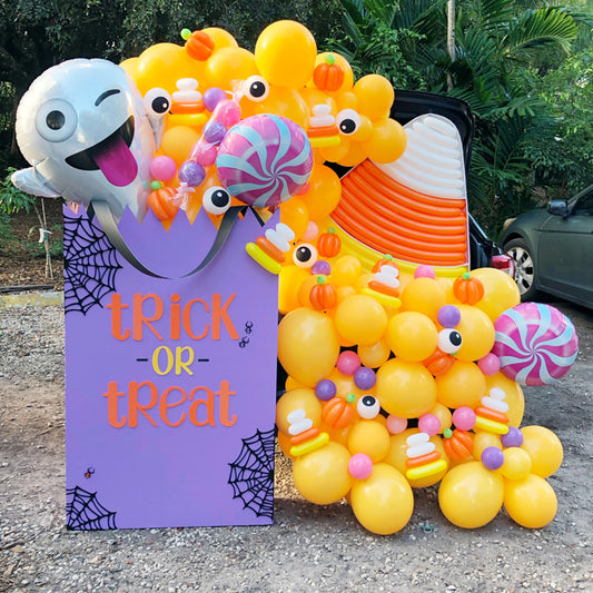 DIY Oversized Trick or Treat bag with candy and ghost balloons. Designed by The Creative Heart Studio