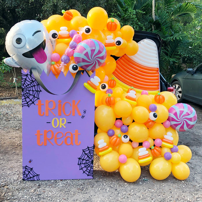 DIY Oversized Trick or Treat bag with candy and ghost balloons. Designed by The Creative Heart Studio