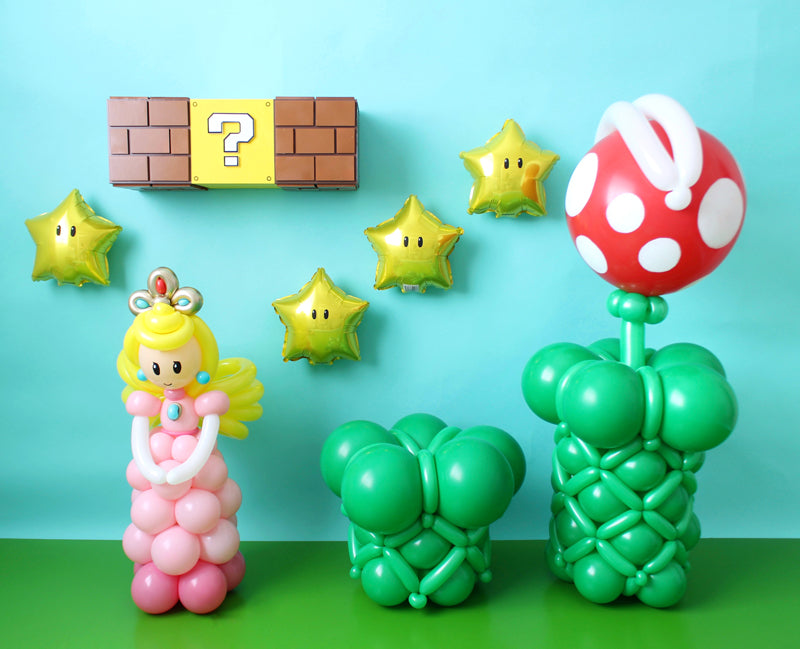 Super Mario Party Decoration Ideas. Star Foil Balloons with eyes. Piranha Plant and princess peach. Luck Box and Bricks decoration made out of foamboard.
